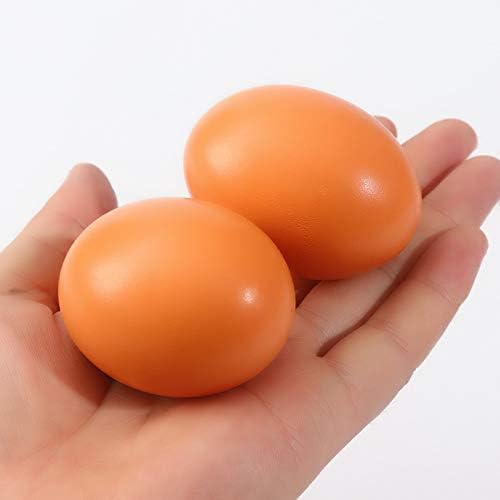 Two wooden eggs in a woman hand